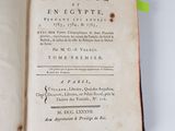 an open book with a yellow ribbon on top of it