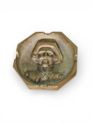 an image of a gold plate with a picture of a man