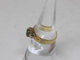 a clear glass with a gold ring on top of it