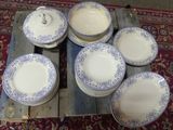 many plates and bowls sitting on a wooden pallet