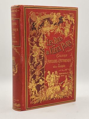 un livre rouge et doré orné d'illustrations dorées
