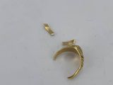 a close up of a gold ring on a white surface