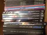 many dvds stacked on top of each other on a shelf