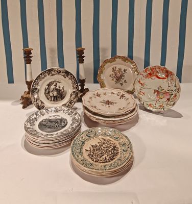 a lot of plates on the table with candlesticks