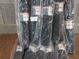 a lot of black plastic bags on top of a wooden table