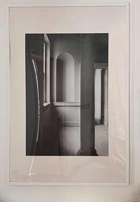 a black and white photo of a hallway in a house