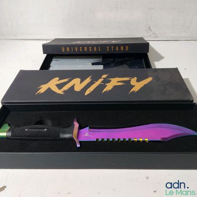 a knife in a black box with a purple handle