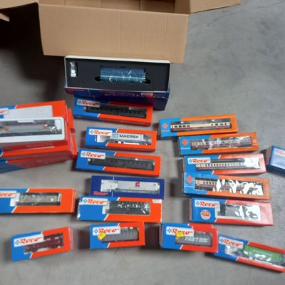 tout un tas de trains miniatures de toutes sortes dans une boîte