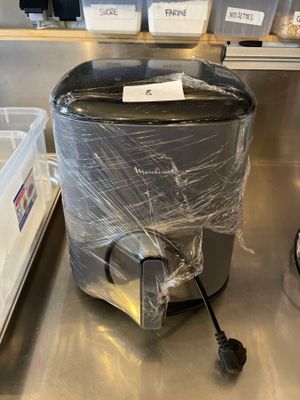 a trash can that is wrapped in plastic on the counter