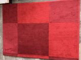 a red and black rug on display in a store