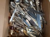 a box full of silver spoons and spoons in it