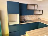 a kitchen with blue cabinets and a wooden counter top