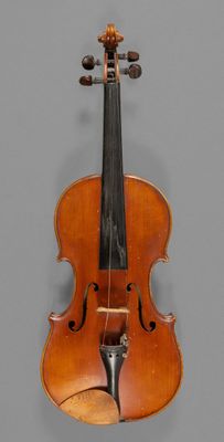 an old violin with a bow hanging on a wall