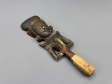 a close up of a wooden carving of a person holding a baseball bat