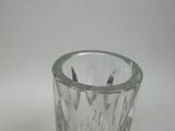 a clear glass cup with a paper napkin inside of it
