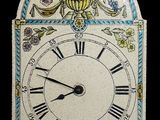 a clock that has been decorated with flowers and leaves