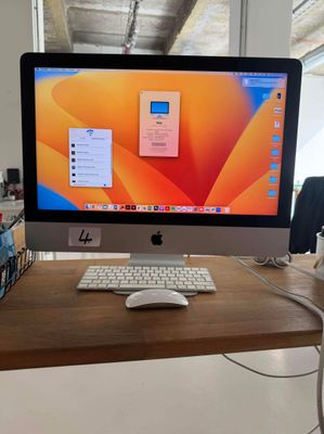 a computer monitor sitting on a desk with a mouse