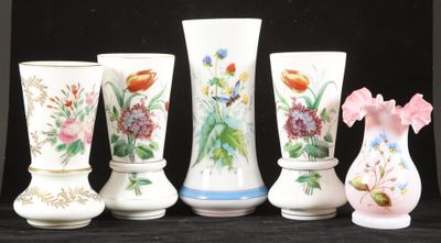 five vases that have been painted with flowers on them