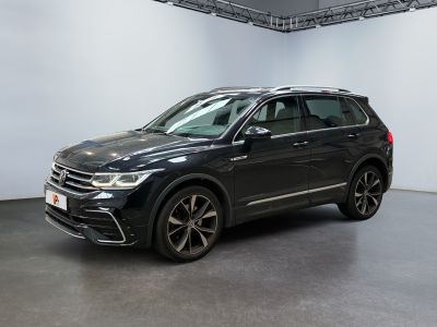 a black volkswagen suv is parked in a large room