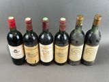 several bottles of wine are lined up in a row