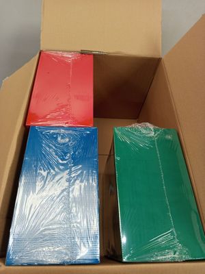 a cardboard box filled with different colored sheets of paper