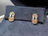 a pair of earrings that are on top of a jacket