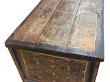 an old wooden chest with ornate carvings on the sides