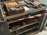 a workbench that has a lot of tools on it