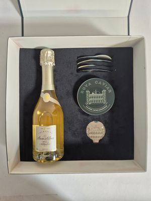 a bottle of wine and a coin in a box