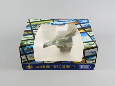 une petite maquette d'avion de chasse dans une boîte