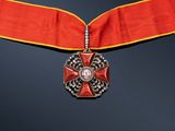 a close up of a red ribbon with a cross on it