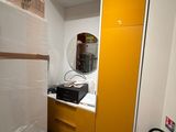 a refrigerator in a room with a lot of boxes on the floor