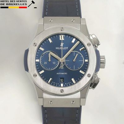 the watch has a blue dial on the face of the watch
