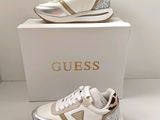 white and gold shoes with a leopard print on the sole