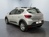the rear view of a silver car parked in a showroom