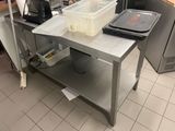 an image of a kitchen with a work table and a microwave