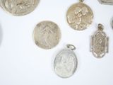 a lot of silver coins on a white surface