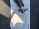 a car key sitting on top of a piece of paper in the back seat of a car