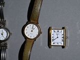 two watches and a watch on display on a table