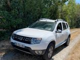 a white car that is parked on a dirt road