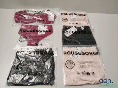 three bags of clothing are sitting on a table