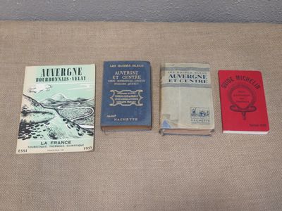 several books are lined up on a table with a brown cloth