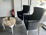 two chairs and a table in a room with a fire extinguisor