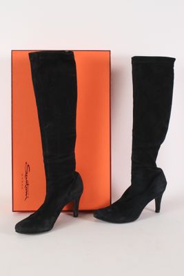 black sued high heel boots with orange box on white background