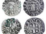 quatre pièces d'argent sur lesquelles sont gravés un crâne et une croix