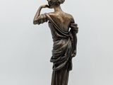 an image of a statue of a woman holding a lamp on top of a table
