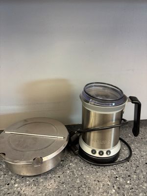 a blender sitting on the counter next to a coffee pot