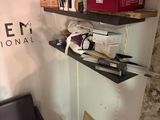 a black chair sitting in front of a wall with a sign that says salon international