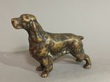 bronze dog figurine on a white background