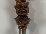 a close up of a metal object with a statue on it